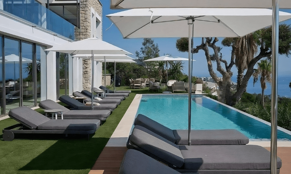 Villa Hotel Bassa Californie in Cannes, French Riviera, France – cozy lounge nook with bookshelf and plush armchairs